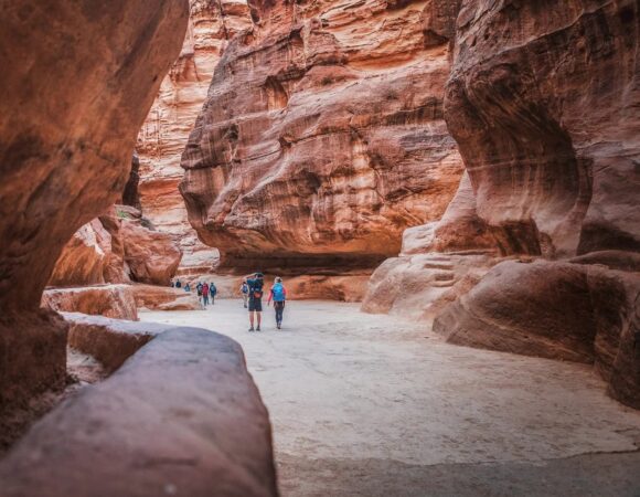 Tourists walking in the Siq in Petra Jordan