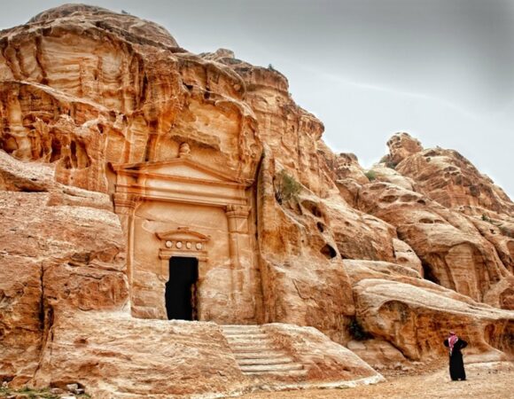 Little Petra Nabataean facade with Bedouin man