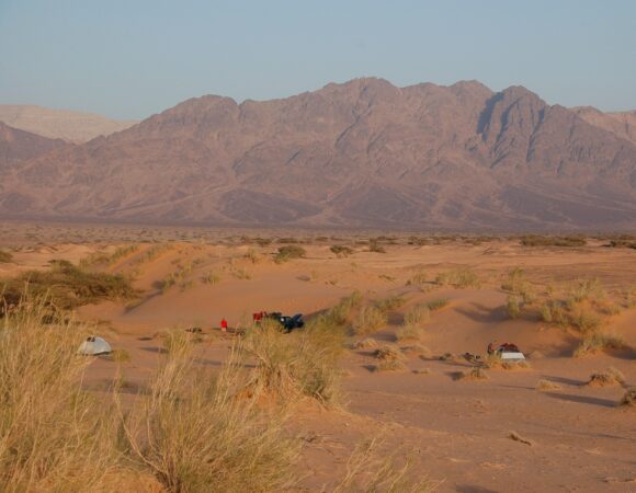 Camping in tents in Wadi Araba desert with mountains in th e back ground