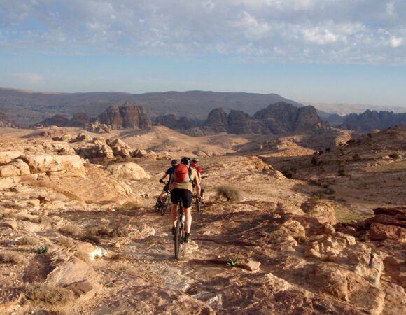 Bikers in the rough landscape on their biking adventure in Jordan