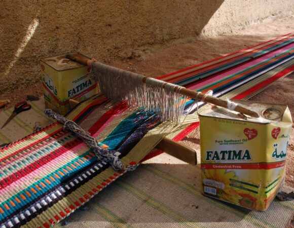 Ground loom of weaving woman in Udruh with colorfull set up