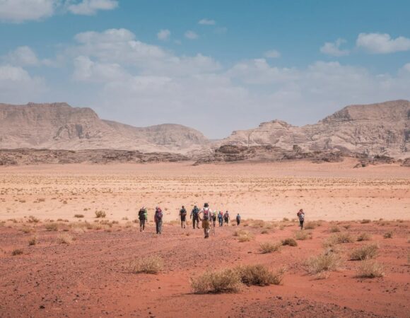 Group of Salma Tours hikers in tje red Wadi Rum sand