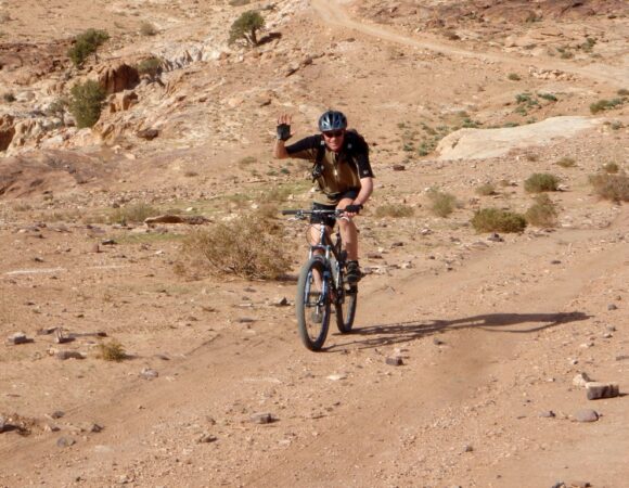 Tourist on mountainbike on way to Little Petra in Jordan