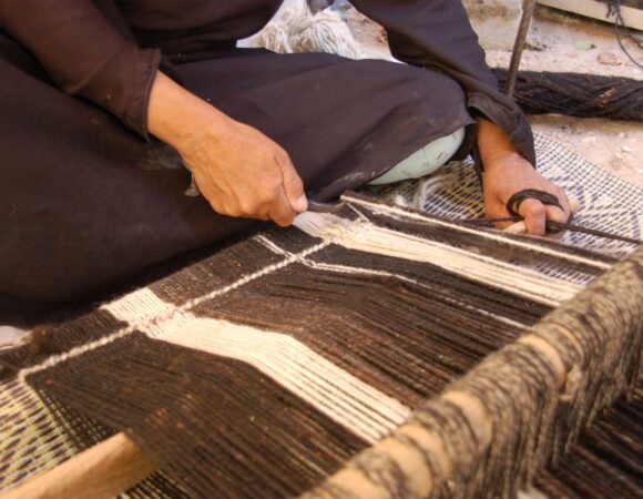Lumeyo weaving woman working on her ground loom