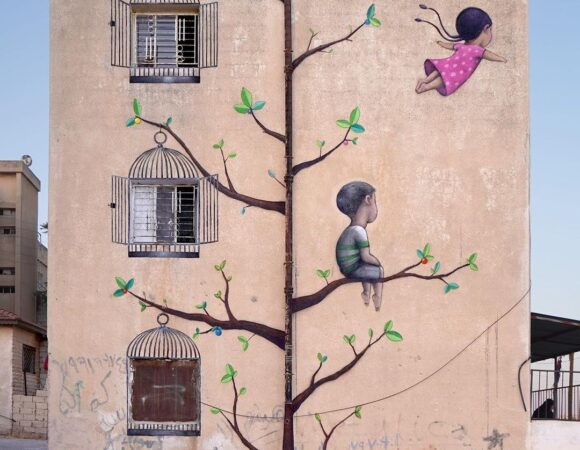 Two kids and a tree on mural Three cages alHashmi Al Shamali mural art Amman